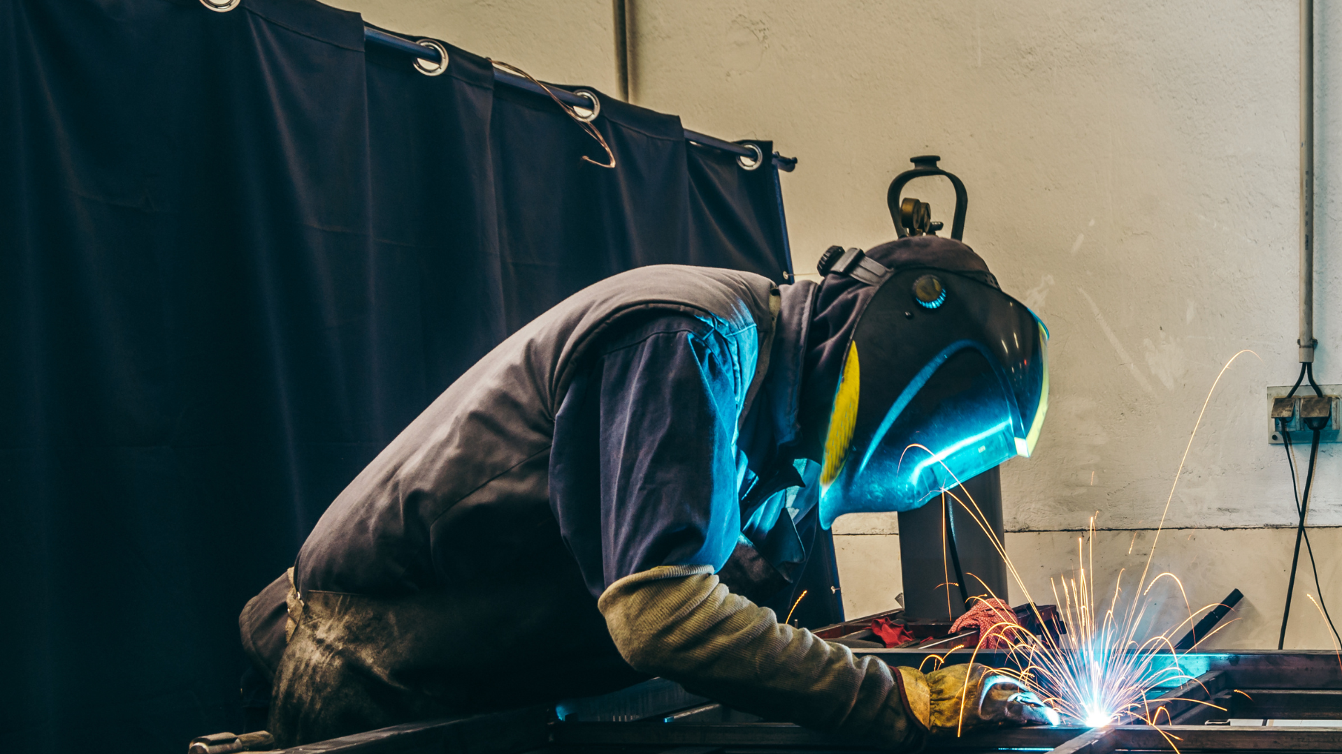 welder welding the frame of a ironside truck body